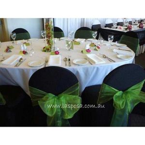 Stunning black lycra chair cover setting with bright green organza sashes.  Premium quality lycra chair covers available